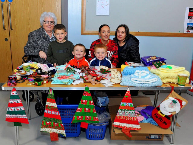 Ann McKeever (left) with Jane Breslin, Kayleigh Breslin, Cael, Quinn and Lenny at her stall at the Christmas Craft Fair held in the Galliagh Community Centre on Saturday afternoon. Photo: George Sweeney. DER2250GS – 74