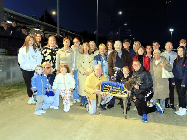 Lornie McMonagle & Track Lotto Memorial Sprint winner Sniper Roro with owner Kevin O’Kane (pictured with his son, Kealan, and between them is his grandson Ronan at the dog’s head) being presented with the trophy by Lornie’s brother, Charlie. The great turnout by Lornie’s partner, family & friends are all testament to the deep affection that he was held in and indeed he is still very much missed. (Photo: Brian Sandow)