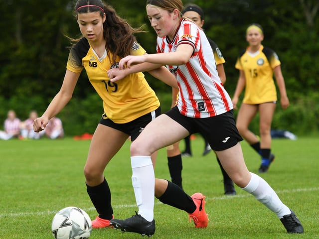 Katy Mooney, Derry City Ladies, and Brooke Immel, Gundo FC, tussle for the ball during their girls under-15's match.