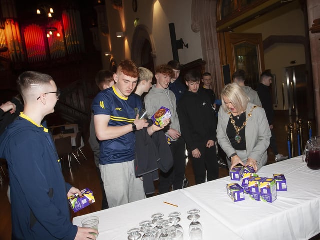 The Mayor Sandra Duffy handing out Easter eggs to the young Don Boscos FC 2007 at Friday night’s 50th anniversary event in the Guildhall.