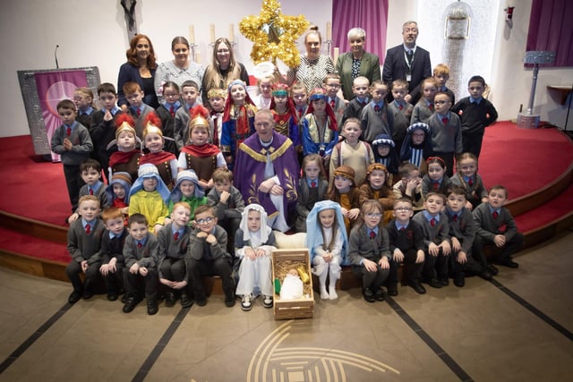 ST. BRIGID'S NATIVITY. . . . .Group pictured on the altar at St. Brigid's Church, Carnhill after Wednesday's St. Brigid's PS Nativity. Included are Mrs Tina. Ruddy, RE/Music Coordinator, Ms. Caitlín Kelly LSA. Mrs. Lynn McCay. Year 3 Teacher, Mrs. Caitríona Quigley, Year 3 Teacher, Mrs. Trudy McLaughlin LSA, Mr. Paul O'Doherty, Principal and Fr. Sean O'Donnell. (Photos: Jim McCafferty Photography)