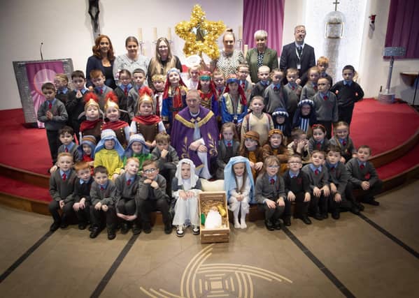 ST. BRIGID'S NATIVITY. . . . .Group pictured on the altar at St. Brigid's Church, Carnhill after Wednesday's St. Brigid's PS Nativity. Included are Mrs Tina. Ruddy, RE/Music Coordinator, Ms. Caitlín Kelly LSA. Mrs. Lynn McCay. Year 3 Teacher, Mrs. Caitríona Quigley, Year 3 Teacher, Mrs. Trudy McLaughlin LSA, Mr. Paul O'Doherty, Principal and Fr. Sean O'Donnell. (Photos: Jim McCafferty Photography)