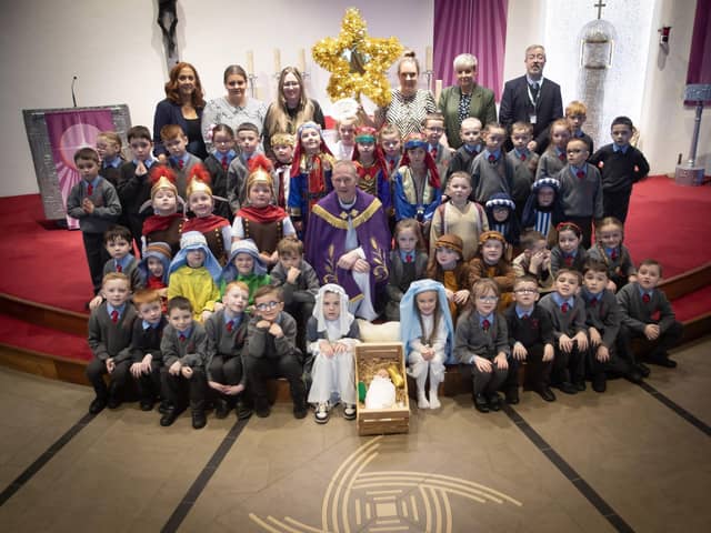 ST. BRIGID'S NATIVITY. . . . .Group pictured on the altar at St. Brigid's Church, Carnhill after Wednesday's St. Brigid's PS Nativity. Included are Mrs Tina. Ruddy, RE/Music Coordinator, Ms. Caitlín Kelly LSA. Mrs. Lynn McCay. Year 3 Teacher, Mrs. Caitríona Quigley, Year 3 Teacher, Mrs. Trudy McLaughlin LSA, Mr. Paul O'Doherty, Principal and Fr. Sean O'Donnell. (Photos: Jim McCafferty Photography)