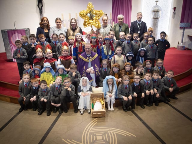ST. BRIGID'S NATIVITY. . . . .Group pictured on the altar at St. Brigid's Church, Carnhill after Wednesday's St. Brigid's PS Nativity. Included are Mrs Tina. Ruddy, RE/Music Coordinator, Ms. Caitlín Kelly LSA. Mrs. Lynn McCay. Year 3 Teacher, Mrs. Caitríona Quigley, Year 3 Teacher, Mrs. Trudy McLaughlin LSA, Mr. Paul O'Doherty, Principal and Fr. Sean O'Donnell. (Photos: Jim McCafferty Photography)