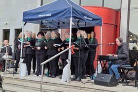 CALMS' community choir, Thyme To Sing performing on the steps of the Council offices as part of the Foyle Maritime Festival's Beyond Blue.