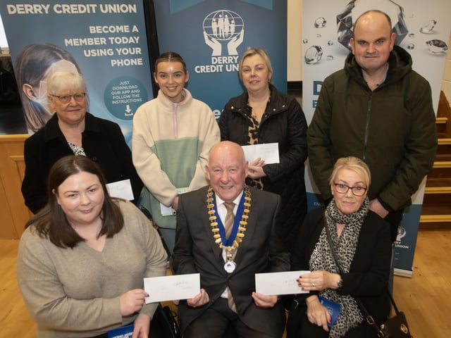 Derry Credit Union president Colm McCauley presenting the £100 prizewinners at Monday night's AGM. Front from left, Colleen Wilson and Bridie Barr. Back from left, Brigid McKeegan, Lauren Clifford, Donna Heaney and Kevin Kelly. : .