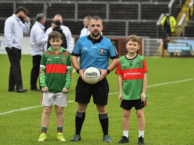 Young footballers from Slaughtmanus and Doire Trasna Under 12 teams pictured with match referee Thomas Devlin prior to throw-in at the Derry Junior Football Championship Final at Celtic Park on Sunday afternoon. Photo: George Sweeney