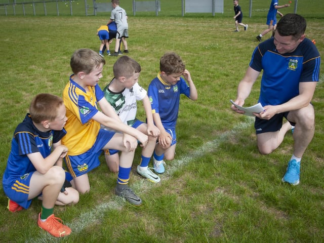 Burt coach Benny Harrigan goes over some of the rules at the Skills Day with these young players.