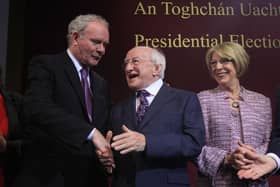 Michael D Higgins (C) and wife Sabina Coyne (R) are congratulated by Martin McGuinness in 2011. AFP PHOTO/ PETER MUHLY (Photo by PETER MUHLY / AFP) (Photo by PETER MUHLY/AFP via Getty Images)