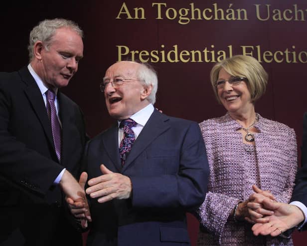 Michael D Higgins (C) and wife Sabina Coyne (R) are congratulated by Martin McGuinness in 2011. AFP PHOTO/ PETER MUHLY (Photo by PETER MUHLY / AFP) (Photo by PETER MUHLY/AFP via Getty Images)