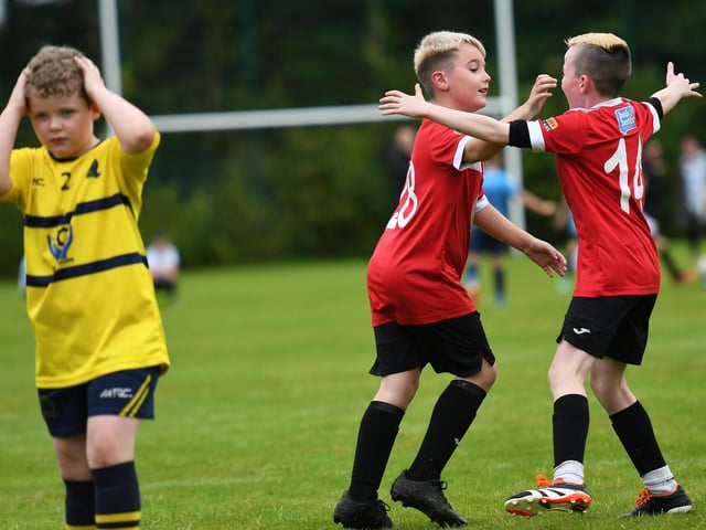 Maiden City Juniors under-10 players Eli Cooke and Seanan Murphy celebrate after a goal against Don Bosco's Juniors at Oakgrove. (Photo: Keith Moore)