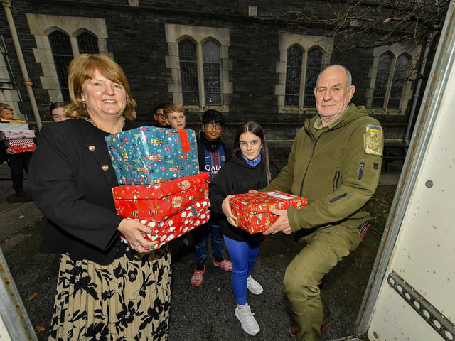 Deputy Mayor Alderman Niree McMorris and Peter Jennings, Derry Ukraine Aid, receive some of the hundreds of Christmas presents for Ukrainian children donated by Lumen Christi College pupils, their families and friends. Photo: George Sweeney