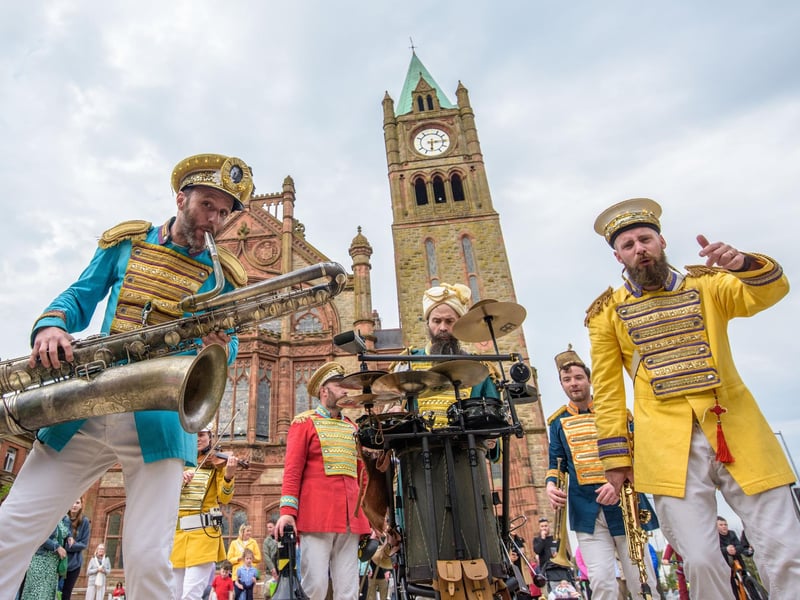 Mr Wilson’s Second Liners take to the streets of Derry as they add a jazz twist to pop music as they make their way round the city centre and inti Guildhall Square . Picture Martin McKeown. 03.05.24