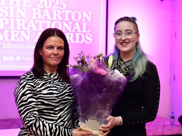 Candace Partridge receiving her presentation from Aine Doherty, daughter of Roisin Barton.