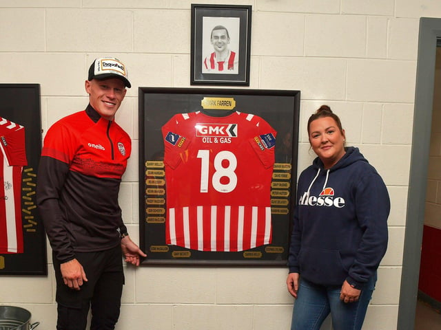 James McClean and Terri Farren pictured beside a framed shirt and sketch of the late Derry City legend Mark Farren, at the Brandywell Stadium on Friday evening . Photograph: George Sweeney. DER2325GS – 69