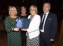 The Mayor, Sandra Duffy making a special presentation to former Hollybush PS Principal Carmel Dunn on her retirement from the school and to mark her overall contribution to education at a function in her honour at the Guildhall on Wednesday evening. Included is Councillor Angela Dobbins and Carmel’s husband Eugene.