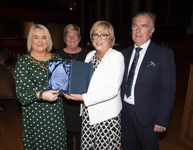 The Mayor, Sandra Duffy making a special presentation to former Hollybush PS Principal Carmel Dunn on her retirement from the school and to mark her overall contribution to education at a function in her honour at the Guildhall on Wednesday evening. Included is Councillor Angela Dobbins and Carmel’s husband Eugene.