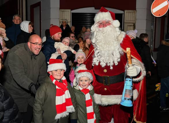 Santa greets children at the Derry Magical Christmas procession on Friday evening. Photo: George Sweeney