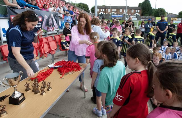 Aisling Hutton, Bogside & Brandywell Health Forum, and Ryan McBride's sister Suinin handing out medals at Wednesday's tournament.