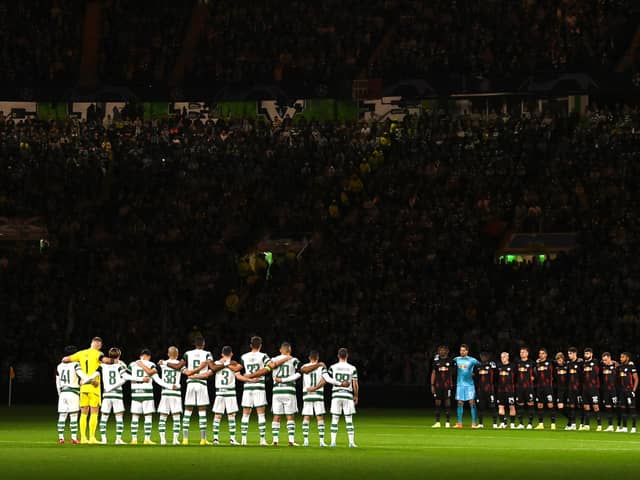 The two teams observe a minute's silence prior to the UEFA Champions League group F match between Celtic FC and RB Leipzig at Celtic Park on October 11, 2022 in Glasgow, Scotland. (Photo by Stu Forster/Getty Images)
