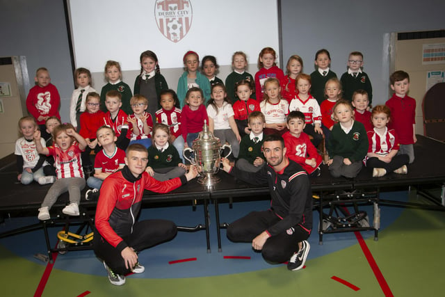 Derry players Caoimhin Porter and Michael Duffy and the FAI Cup pictured with the P1 classes at Greenhaw PS.