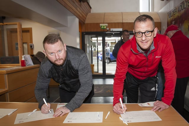 SIGNING IN!. .. . . .The first two through the door signing in for the Men’s Health Day at the Old Library Trust, Creggan on Saturday last, as part of International Men’s Day were Sean Harris and Denis McLaughlin. (Photos: Jim McCafferty Photography)