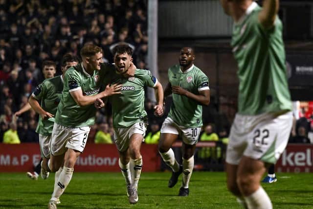 Adam O'Reilly of Derry City, centre, celebrates with teammates after scoring their side's second goal.