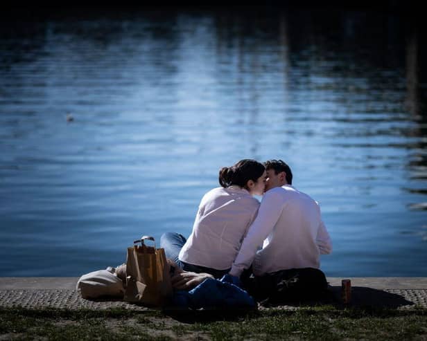 A couple kisses on the Garonne river bank in Toulouse, southwestern France on February 8, 2022. - Valentine's Day is celebrated annually on February 14. (Photo by Lionel BONAVENTURE / AFP) (Photo by LIONEL BONAVENTURE/AFP via Getty Images)