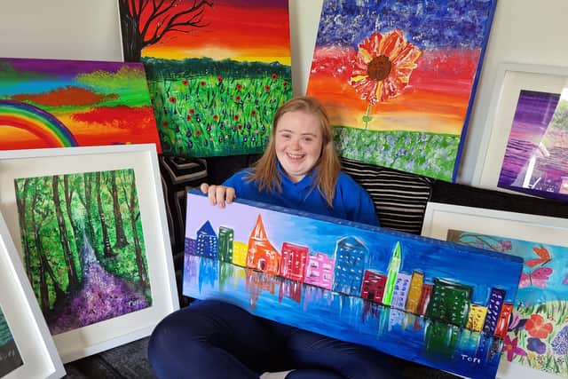 Tori McNeill with a collection of her work.