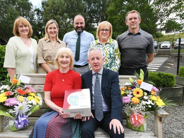 Mrs. Mary Grace, seated, who is retiring from her post as Head of Nursery at Hollybush Primary School after 25 years service, pictured after a presentation ceremony at the school with her husband Declan. At back from left are, Yvonne Bradley, Margaret Harkin, senior teacher, Feargal Friel, Acting Principal, Carmel Dunn, retired principal, and Francis Mallon, senior teacher. (Photos: Keith Moore/Jim McCafferty Photography)