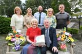 Mrs. Mary Grace, seated, who is retiring from her post as Head of Nursery at Hollybush Primary School after 25 years service, pictured after a presentation ceremony at the school with her husband Declan. At back from left are, Yvonne Bradley, Margaret Harkin, senior teacher, Feargal Friel, Acting Principal, Carmel Dunn, retired principal, and Francis Mallon, senior teacher. (Photos: Keith Moore/Jim McCafferty Photography)