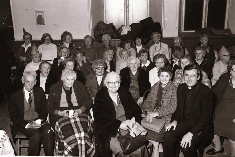 Fr Con McLaughlin with parish residents at the Long Tower Senior Citizens Christmas Party in December 1983.