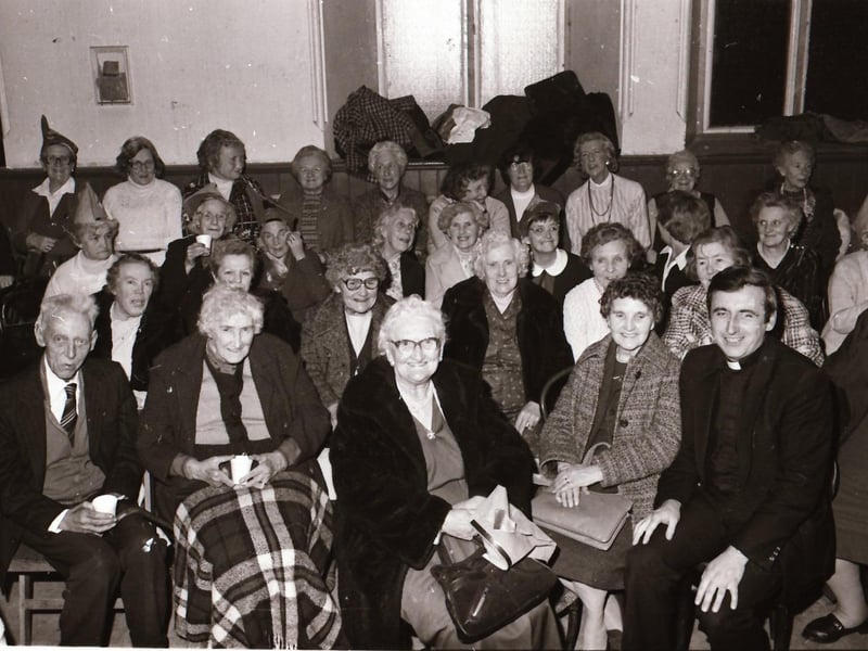 Fr Con McLaughlin with parish residents at the Long Tower Senior Citizens Christmas Party in December 1983.
