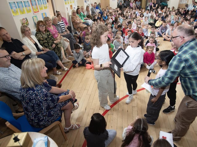 Pupils presenting some gifts and reading poetry to Mrs. Ramsey on Friday last.