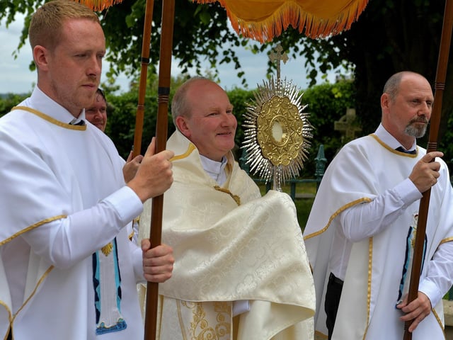 Fr. Gerard Mongan, administrator of St Columba’s Church, Long Tower, carries the Blessed Sacrament at the Solemnity of Corpus Christi procession, in the ground of the church on Sunday afternoon. Photo: George Sweeney. DER2324GS –