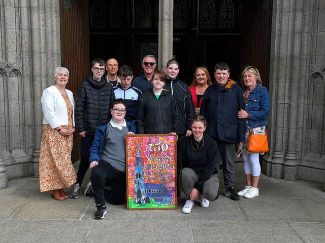 Pupils and staff from Ardnashee School and College pictured at St Eugene’s Cathedral recently with an artwork they created for the cathedral’s 150th anniversary. The art work is made up of 42 7x8cm rectangles that pupils used a pointillism technique with their fingers and cotton wool buds. Included in the photograph are Therese Ferry, Diocesan Advisor, on the right, Adrian Newton, art project leader, third from right, and Anne Marie Hickey, Pastoral Co-ordinator, third from left. Photo: George Sweeney.  DER2320GS – 51