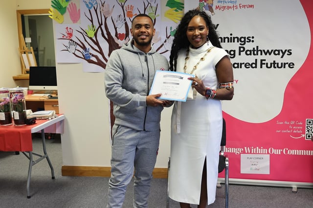 Ahmed Osama receiving his certificate from Mayor Lilian Seenoi Barr.