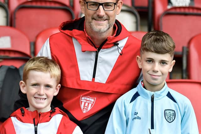 Joe Doherty and sons pose for a photograph at the Brandywell on Sunday.