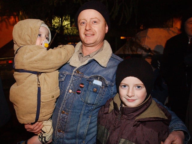 Enjoying Santa's visit are, from left, Mairtin, Pat and Caolan Melarkey. (0612PG59)                                : Christmas in Inishowen in 2005.