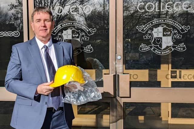 Mr Stephen Gallagher, principal of Loreto College, Coleraine, excitedly taking delivery of his new headgear
