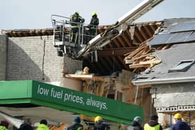 Firefighters attend a wrecked apartment block and service station in Creeslough after a catastrophic explosion that killed 10 people.