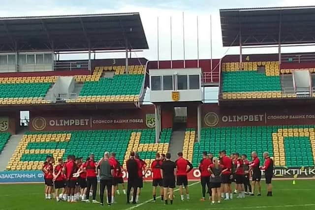 Derry City players have a discussion on the pitch at the Central Stadium in Kostanay.