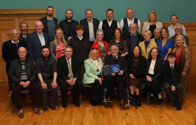Mayor Sandra Duffy making a presentation to sculptor Maurice Harron, in recognition of his contribution as an art educator and artist in the City and District at a civic reception held in the Guildhall. Included are friends and family. (Photo - Tom Heaney, nwpresspics)