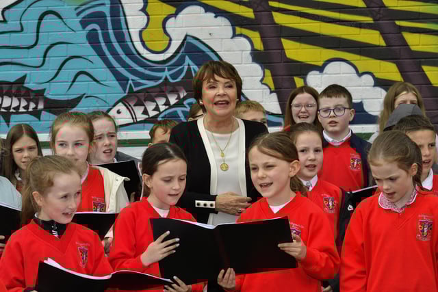 Dana Rosemary Scallon and pupils from St Eugene's Primary School's choir sing 'All Kinds of Everything' at the mural of St Columba, in Columbcille Court, celebrating the patron saint of Derry's feast day.  Photo: George Sweeney