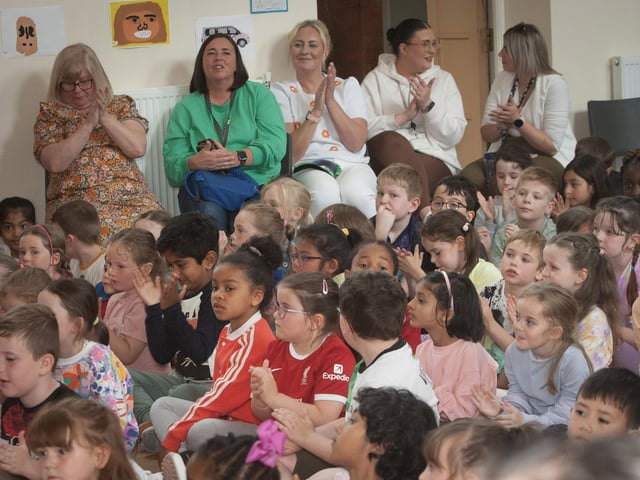 Teaching staff and pupils applaud the choir who performed at Friday's retirement event for Principal Mrs. Michelle Ramsey.