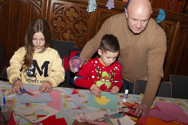 Dad giving a helping hand during Saturday's Arts and crafts in the Guildhall.:.