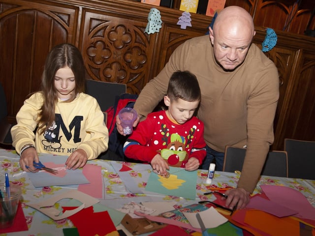 Dad giving a helping hand during Saturday's Arts and crafts in the Guildhall.:.