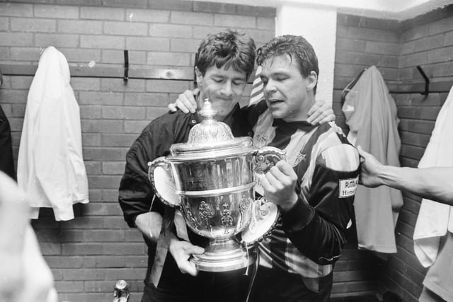 Derry City captain Dermot O'Neill with the trophy in the changing room.