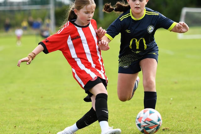 Tristar's Clara O'Doherty fires the ball past Sion Swifts player Eve Connolly during their Girls Under-11 match at Wilton Park.