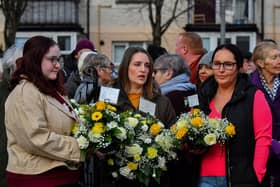 Relatives of those murdered on Bloody Sunday carry floral tributes at the annual service held on Sunday morning. Photo: George Sweeney